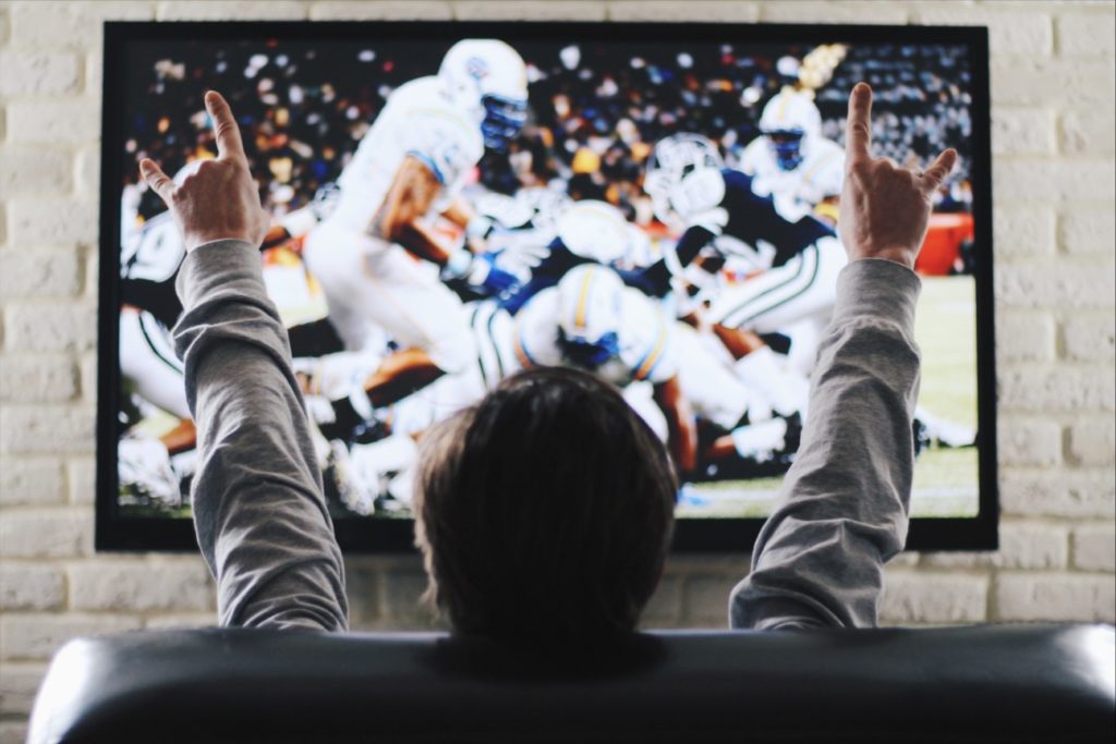 man watching football on tv
